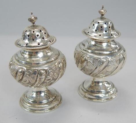 A pair of Victorian silver pepper pots