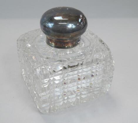 A cut glass square section inkwell