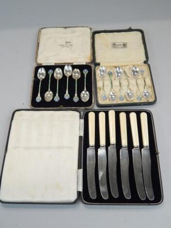 Two sets of six associated silver and enamel coffee spoons