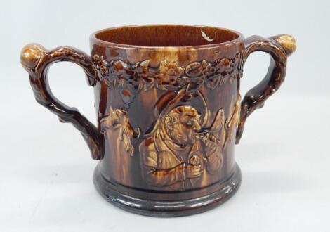 An unusual 19thC two handled treacle glazed loving cup