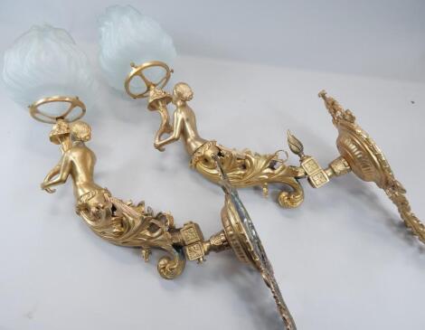 A pair of gilt metal wall lights