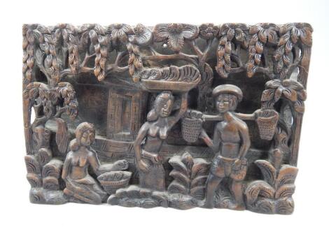 An Eastern carved wooden wall plaque