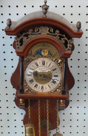 A reproduction mahogany wall clock