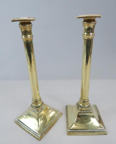 A pair of 19thC brass column candlesticks