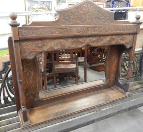 An early 20thC carved oak over mantel mirror