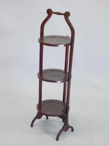 An early 20thC mahogany three tier cake stand