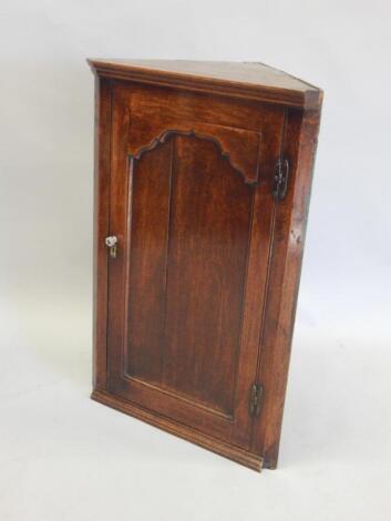 A late 18thC / early 19thC oak hanging corner cabinet