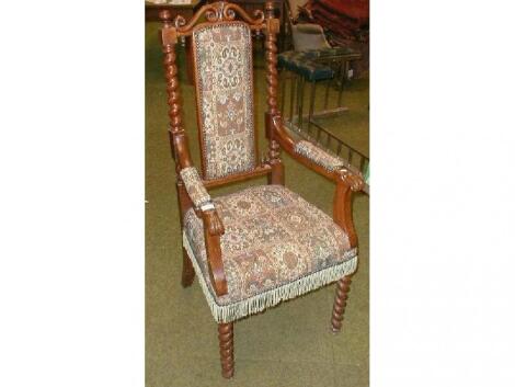 An Edwardian oak open armchair