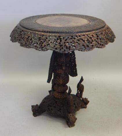 A 19thC Burmese carved teak occasional table