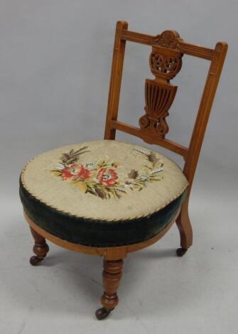 A Victorian walnut nursing chair