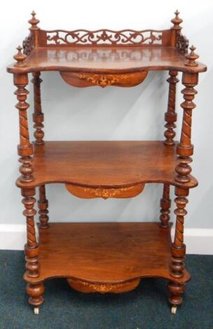 A Victorian figured walnut three tier what not