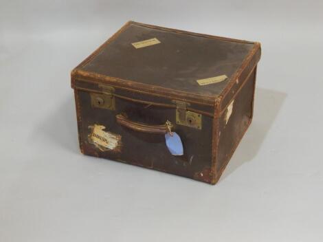 A small canvas and leather bound cabin trunk