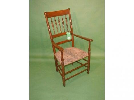 An early 20thC spindle back open arm chair