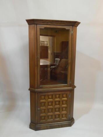 A modern Ercol style oak standing corner cabinet