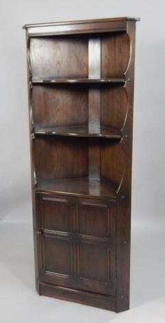 An Ercol stained elm corner cabinet