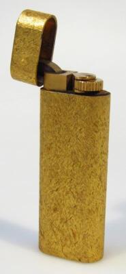 A Cartier gilt cigarette lighter