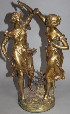 An early 20thC brass sculpture of two ladies