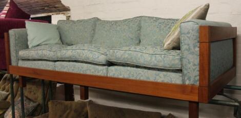 A stained three seater bench with associated cushions