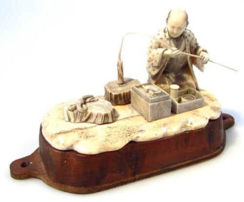 A late 19thC Japanese Meiji period okimono ivory figure group of a gentleman holding staff