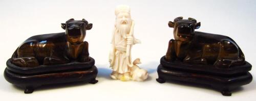 A pair of carved tiger's eye figure groups