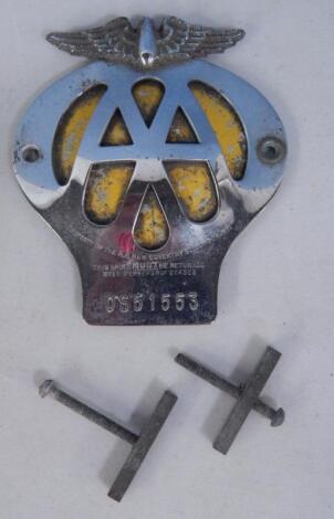 An AA aluminium and yellow enamel car badge