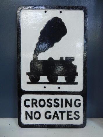 A cast aluminium Crossing No Gates sign