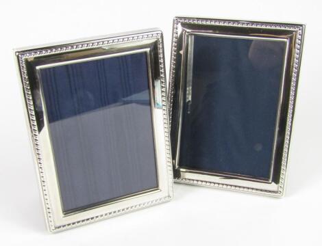 A pair of silver strut photograph frames