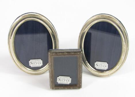 A pair of oval silver strut photograph frames