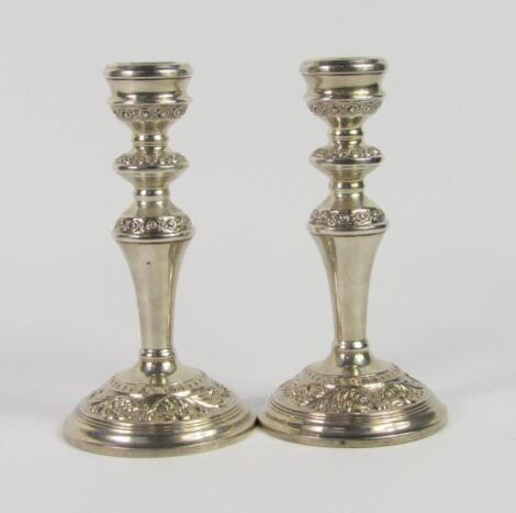 A pair of silver baluster candlesticks