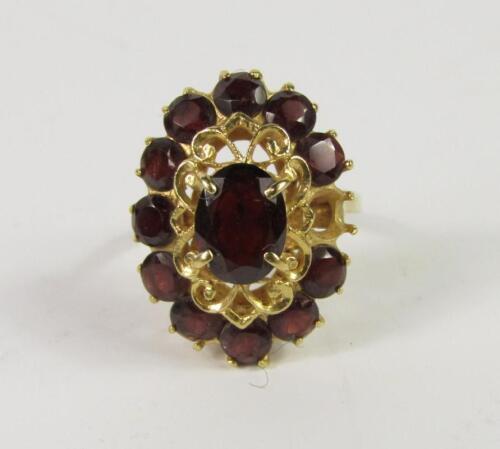 A garnet set oval cluster ring