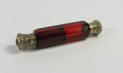 A Victorian cranberry faceted glass double ended scent and smelling salts bottle