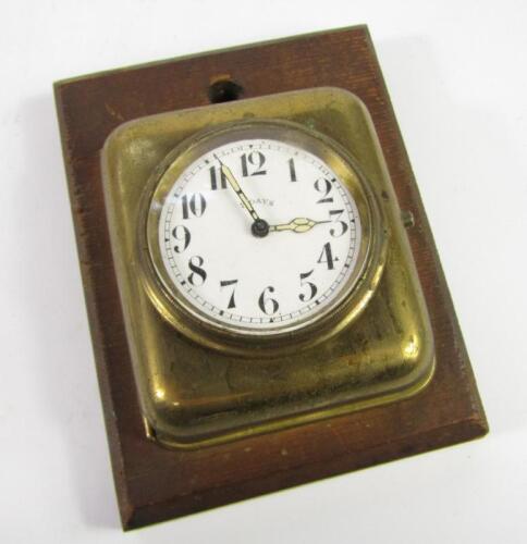 An early 20thC French brass cased wall mounted bedroom clock