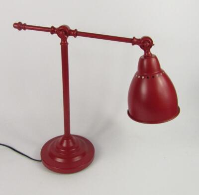 A red metal anglepoise lamp