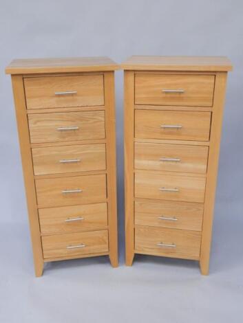 A pair of modern light oak narrow chests of drawers