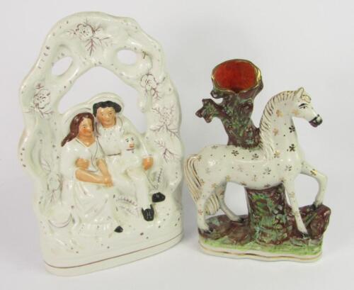 A Staffordshire 19thC pottery flatback figure group of lovers under an arbour