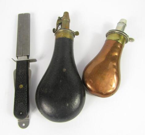 A black leather bound and brass powder flask