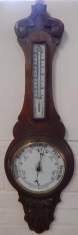 A Victorian oak cased aneroid wheel barometer