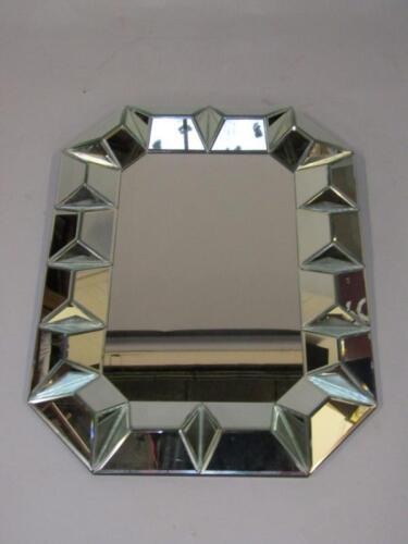 A rectangular glass wall mirror