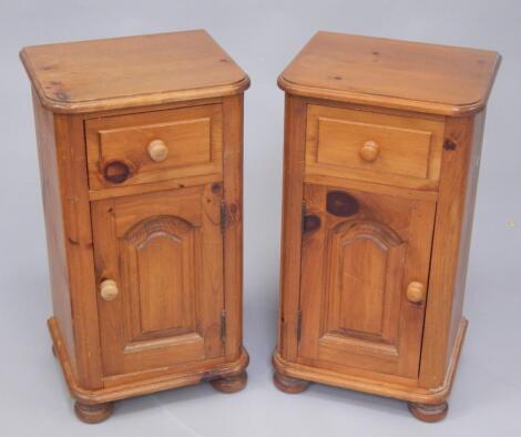 A pair of pine bedside pot cupboards