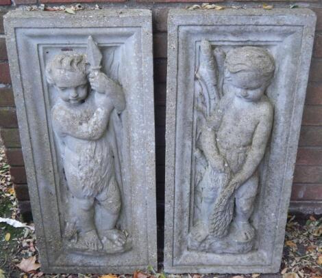 A pair of concrete plaques decorated with putti