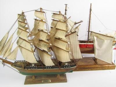 A wooden scale model of a two masted sailing vessel