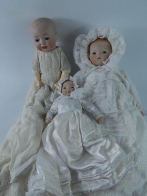 A collection of composite doll parts and complete dolls