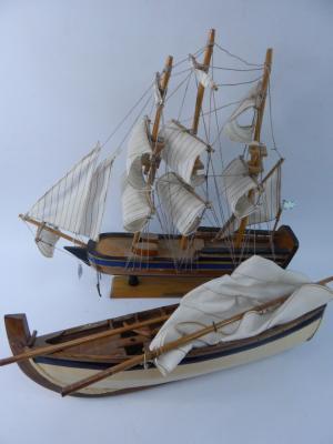 Two wooden models entitled Endeavour and a rowing boat.