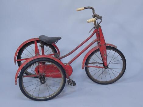 A 1950's red child's tricycle.