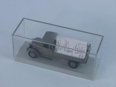 A diecast model of a grey vintage truck