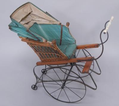 A Victorian cast iron and wicker doll's hand cart.