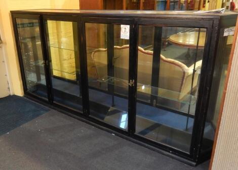 *An early 20thC ebonised shop display cabinet