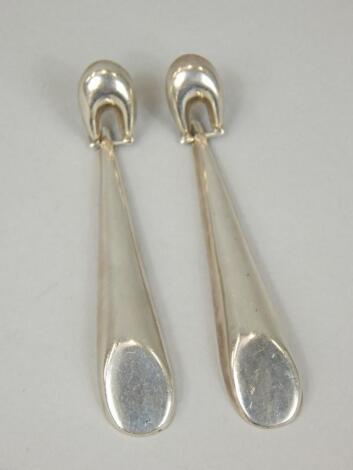 A pair of silver drop earrings