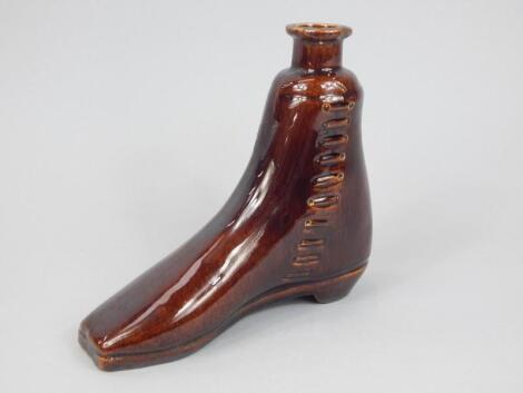 A 19thC treacle glazed stoneware whiskey flask or boot warmer
