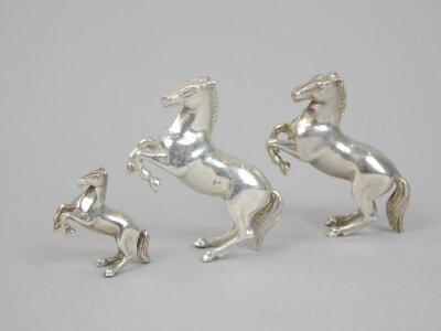 Three various white metal figures of horses